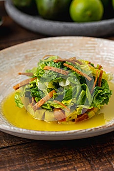 Ensalada de aguacate with various sauces on wooden table