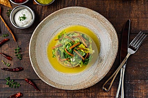 Ensalada de aguacate with various sauces on wooden table