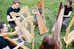 Ensemble of six young musicians play harps
