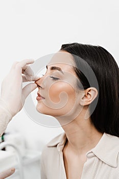 ENT consultation before rhinoplasty plastic surgery. Rhinoplasty is surgical procedure that involves altering shape of