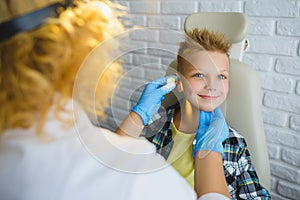 Ent doctor or Otolaryngologist examining a kid ear