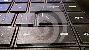 Enter button or key of black laptop.