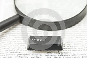 Enter Computer Key and a Lens on a Book Page