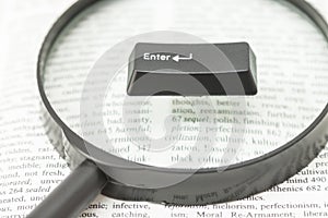 Enter Computer Key and a Lens on a Book Page