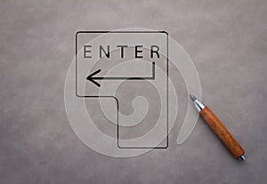 ENTER symbol with sketch on grey backhround