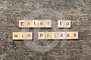 Enter to win prizes word written on wood block. Enter to win prizes text on cement table for your desing, Top view