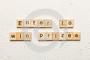 Enter to win prizes word written on wood block. Enter to win prizes text on cement table for your desing, Top view
