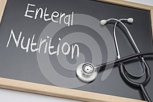 Enteral nutrition written on a blackboard, conceptual image