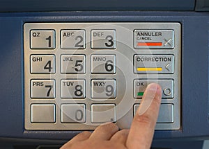 Entering nip code numbers in cash machine by pressing buttons photo