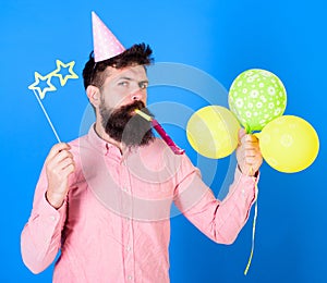 Entertainer with colorful baloons at kids party, international childrens day. Bearded artist with party wistle and paper