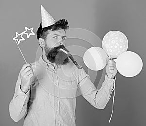 Entertainer with colorful baloons at kids party, international childrens day. Bearded artist with party wistle and paper