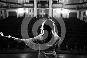Entertainer performing on a stage in a empty theater,concert hall without fans.No audience.COVID-19 canceled show.Opera house photo