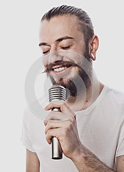 The entertainer. Young talking man holding microphone, Isolated on white background.