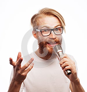 The entertainer. Young talking man holding microphone, Isolated on white background.