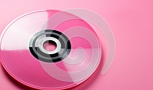 Entertainment and media technology from the 90's .Music cd's dvd's flat lay on pink background top view with