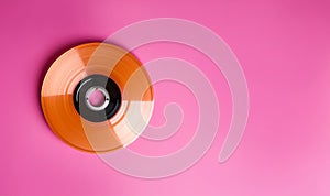 Entertainment and media technology from the 90's .Music cd's dvd's flat lay on pink background top view with