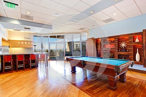 Entertainment room with pool table and walkout deck photo
