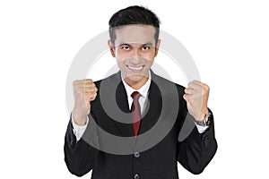 Enthusiastic businessman with clenched fists, isolated on white