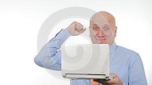 Enthusiastic Businessman Use a Laptop for Communication and Gesticulate Happy
