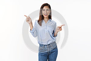 Enthusiastic carefree adult woman dancing lucky upbeat, feeling happy relaxed, joyfully pointing sideways two choices