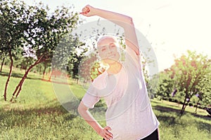 Enthusiastic elderly woman doing exercises outdoors