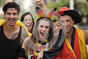 Enthusiastic German sport soccer fans celebrating victory.