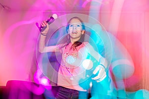 Enthusiastic girl playing on a computer console