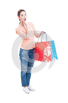 Enthusiastic and happy woman holding shopping bags