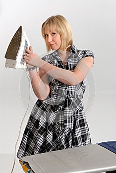 Enthusiastic housewife ironing photo