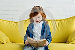 Enthusiastic little child reading book