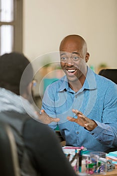Enthusiastic Man in Office with Colleague or Client