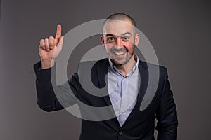 Enthusiastic man pointing upwards with her index finger