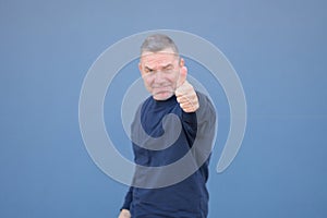 Enthusiastic middle aged man giving a thumbs up gesture with a beaming smile