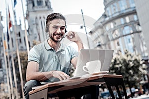 Enthusiastic millennial guy having business video call on laptop