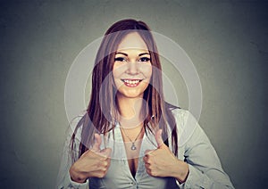 Enthusiastic motivated woman giving a thumbs up gesture of approval