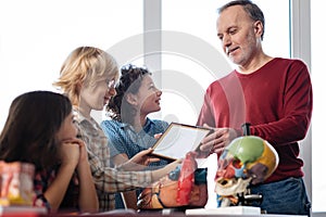 Enthusiastic original teacher awarding his students