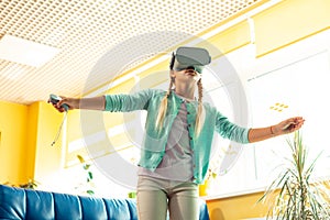 Enthusiastic schoolgirl being wrapped up in virtual reality.