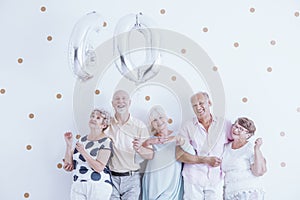 Enthusiastic seniors with silver balloons photo