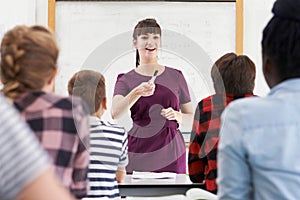 Enthusiastic Teacher With Class Of Teenage Students photo