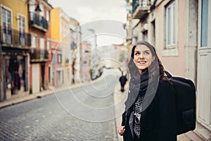 Enthusiastic traveler woman walking streets of european capital.Tourist in Lisbon,Portugal