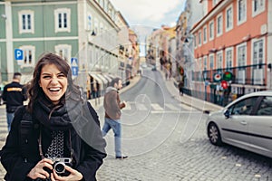 Enthusiastic traveler woman walking streets of european capital.Tourist in Lisbon,Portugal