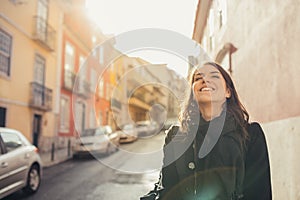 Enthusiastic traveler woman walking streets of european capital.Tourist in Lisbon,Portugal