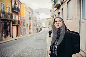 Enthusiastic traveler woman walking streets of european capital.Tourist in Lisbon,Portugal photo
