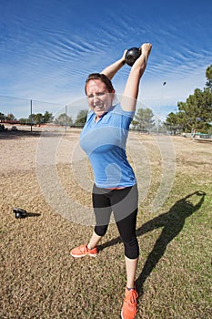 Enthusiastic Woman Exercising Outdoors photo