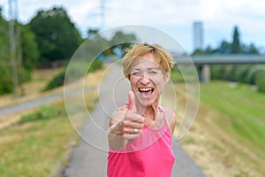 Enthusiastic woman giving a thumbs up gesture