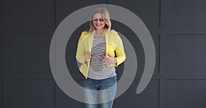 Enthusiastic woman posing in yellow blazer