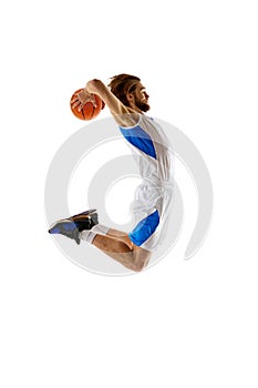 Enthusiastic young man, basketball player participating. training isolated on white background. Game preparation