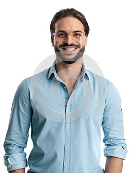 enthusiastic young man with beard and glasses looking forward and smiling