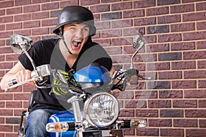 Enthusiastic young man riding his motorbike