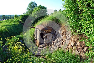 Entrance of an abandoned stone chapel near the spring. Spring, Holy spring of the virgin Mary in the village of Vydropuzhsk,